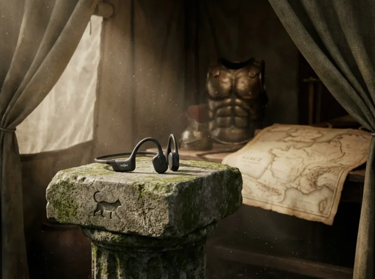 Le Shokz OpenRun Pro 2, casque à conduction osseuse leader de 2026, exposé sur un socle de pierre dans une tente de commandement romaine, illustrant la stratégie de vigilance auditive et la performance tactique.